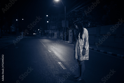 Horror woman concept,Ghost on the road in the city,A vengeful spirit on the street of the town,Halloween festival,Make up ghost face photo
