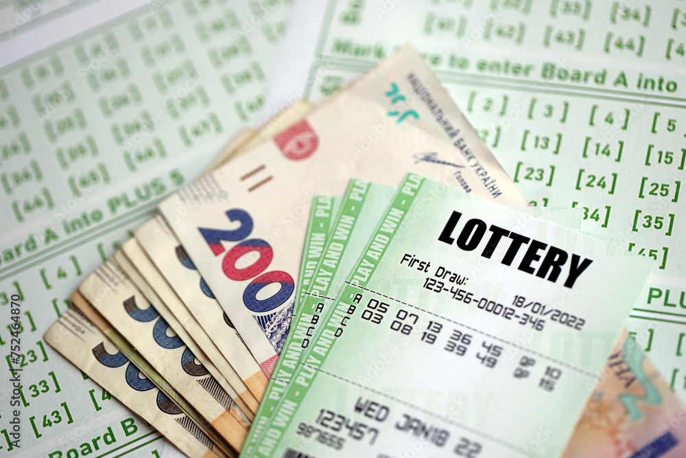 Green lottery tickets and ukrainian money bills on blank with numbers for playing lottery close up Green lottery tickets and ukrainian money bills on blank with numbers for playing lottery close up
