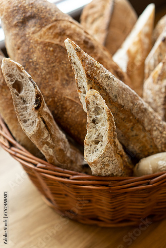 Homemade baguettes in a basket closeup on a dark background