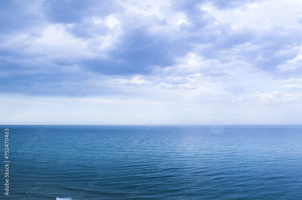 Calm windless ocean in blue tones.