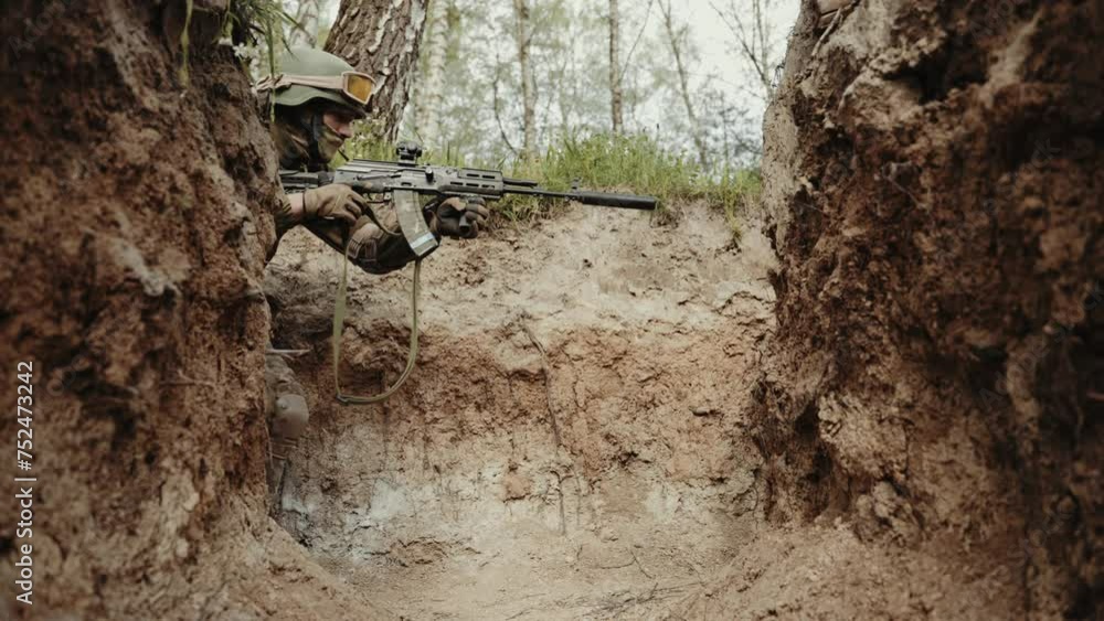 Military Sniper in Concealment. Soldier in sniper camouflage aiming a rifle in a dugout. Military Sniper in Concealment. Soldier in sniper camouflage aiming a rifle in a dugout.