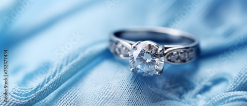 Wedding ring with diamonds on blue satin background, closeup. Perfect for jewelry store advertisements or engagement-related content with Copy Space.