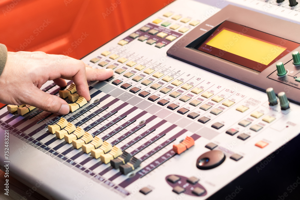male sound engineer hand working on audio mixing console. recording concept male sound engineer hand working on audio mixing console. recording concept