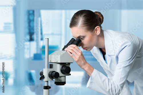 young scientist work with a microscope in modern lab.
