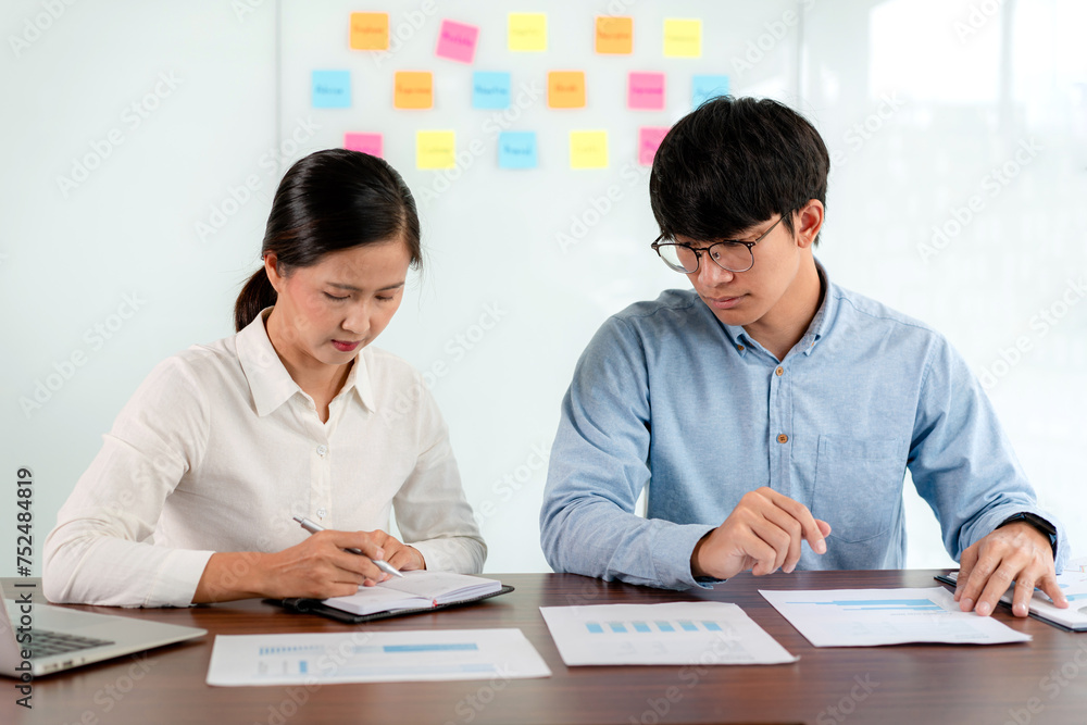 Business executive team brainstorm and takes notes on keyword about a new business project for marketing planning together in the office Business executive team brainstorm and takes notes on keyword about a new business project for marketing planning together in the office