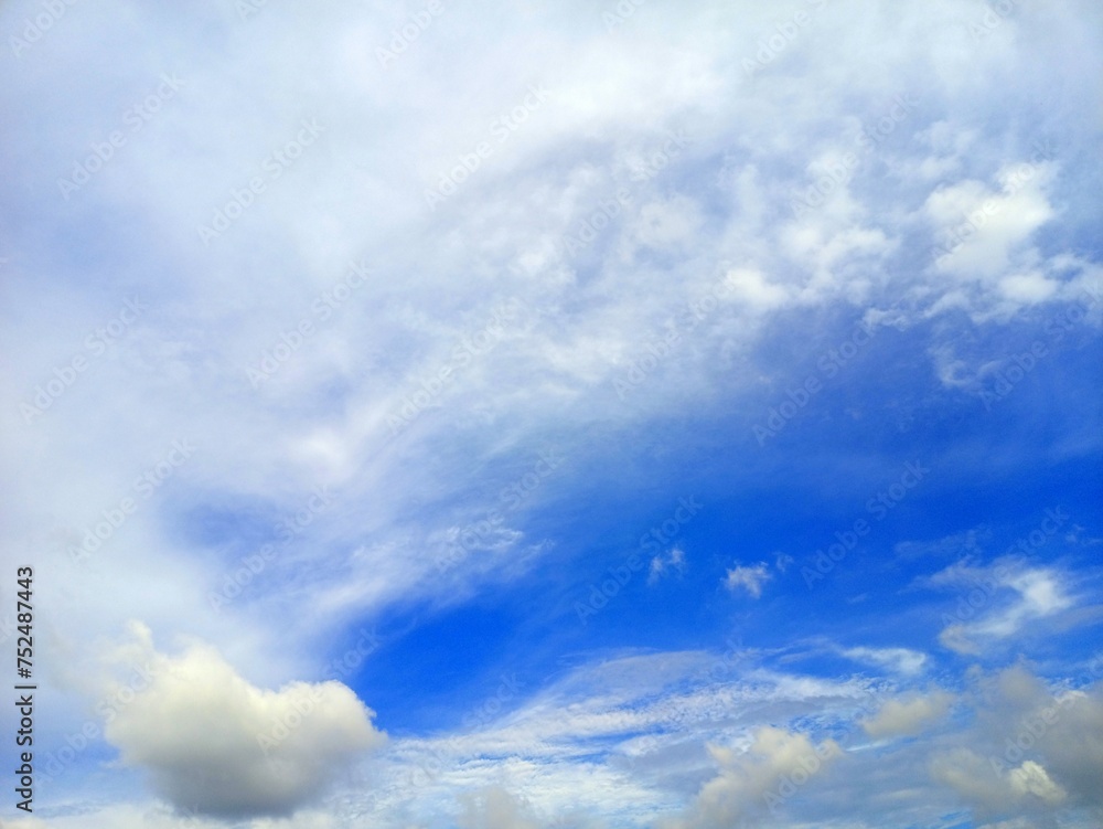 Blue sky background with tiny clouds. Natural background of blue sky.