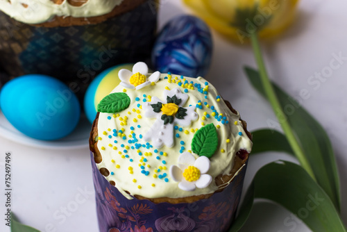Top view of apetite Easter pastries. Easter cake, eggs and spring flowers photo