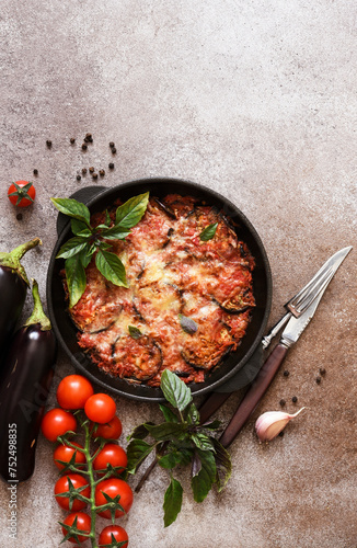 Casserole with eggplant, tomato sauce and cheese, top view, with space for text. Moussaka.