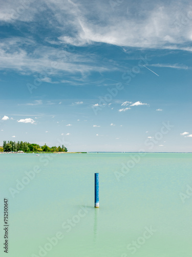 A blue lonely pole in the lake Balaton on a perfect summer day.