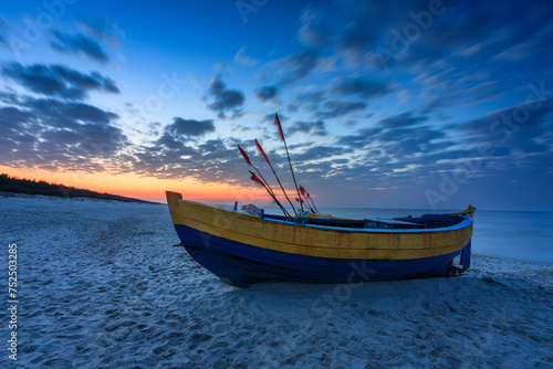 Fishing boats on the Baltic Sea beach in Jantar at sunset. Poland