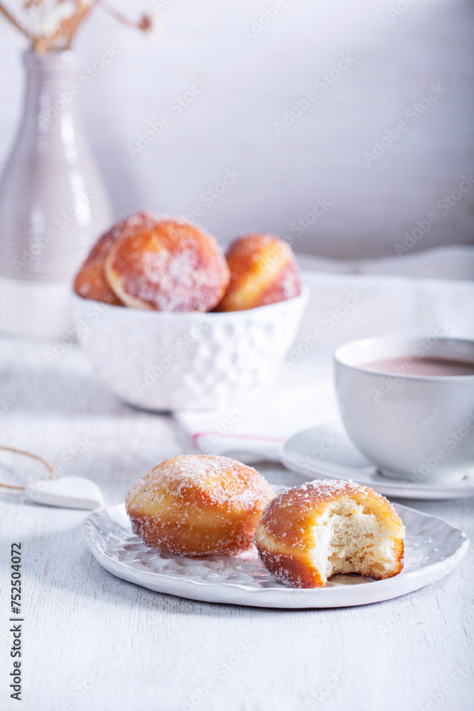 Donuts with sugar and cinnamon served with cocoa. Traditional dessert for Carnival.