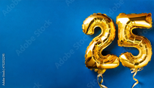 Banner with number 25 golden balloon with copy space. 25 years anniversary celebration. Blue background.