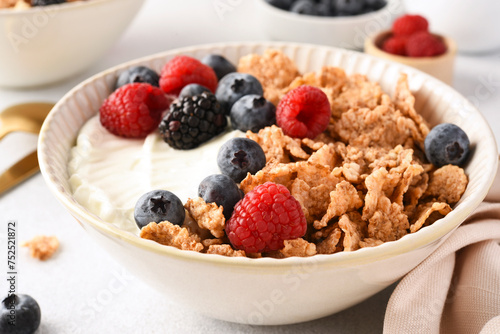 Breakfast with yogurt cereals and berries.