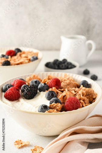 Breakfast with yogurt cereals and berries.