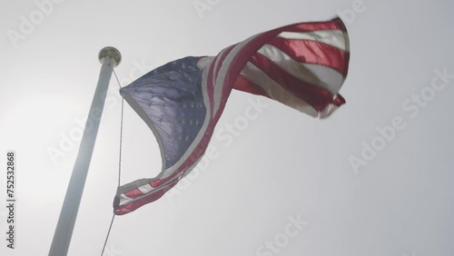 American Flag Blowing in Wind with Sun Flare