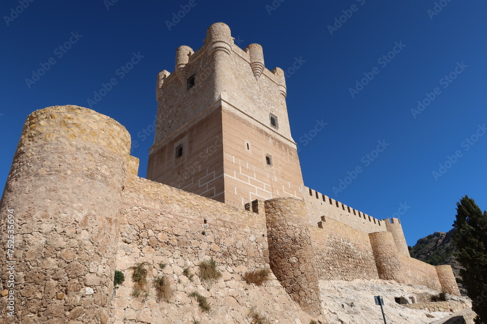 Villena, Alicante, Spain, March 6, 2024: Tower and strong stone defensive walls of the medieval Atalaya Castle of Arab origin. Villena, Alicante, Spain