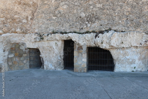 Villena, Alicante, Spain, March 6, 2024: Ancient cave houses at the base of the medieval castle of Arab origin of Atalaya. Villena, Alicante, Spain photo