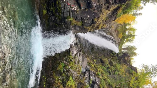 A beautiful waterfall in the autumn mountains beyond the Arctic Circle in the north, in Khibiny, Murmansk region. Panoramic view of a beautiful waterfall in the mountains in autumn, Kola Peninsula 4К photo