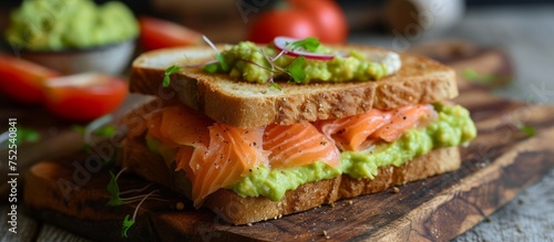 Delicious homemade sandwich with smoked salmon and guacamole on rustic wooden table