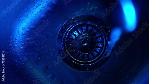 
Close-up of water pouring into a sink in the kitchen. Plumbing, faucet
