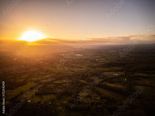 A sunset aerial view of Cheltenham and the Gloucestershire countryside, with distant fields, racecourse and farms