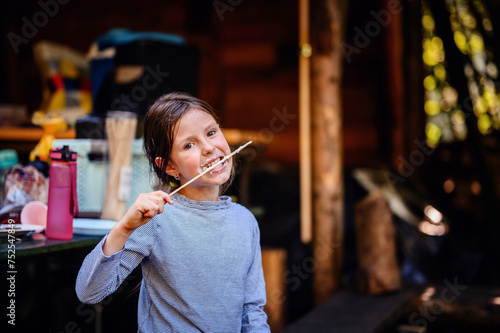 A young girl enjoys the sticky sweetness of marshmallows, a joyful and messy part of outdoor family gatherings