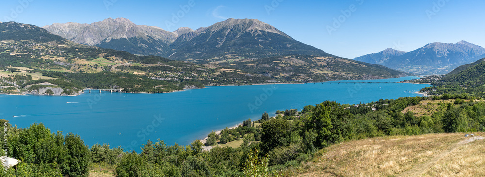Wide panoramic view of the Lake of Serre-Poncon, a popular summer destination in the French Alps