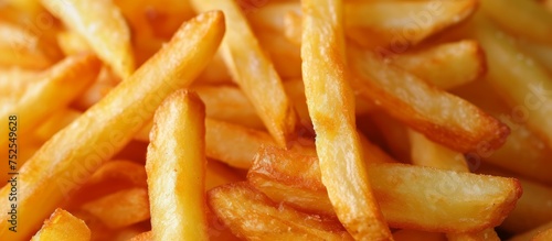 Delicious pile of crispy golden French fries, tasty fast food snack concept