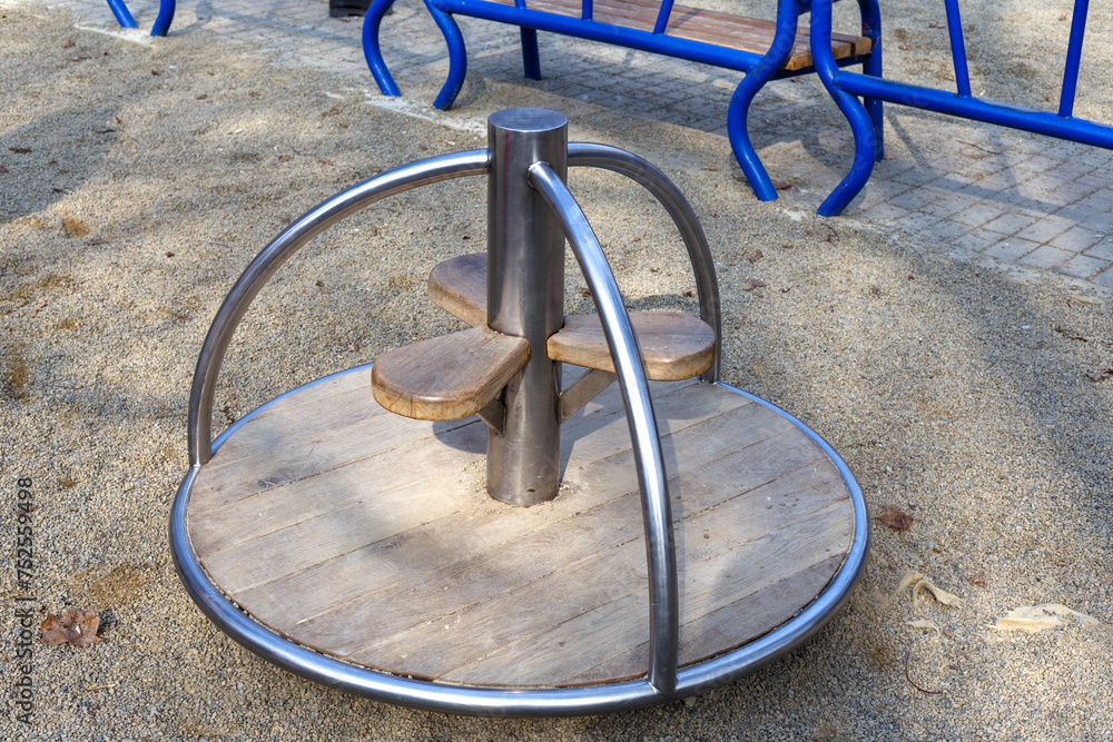 Children's carousel on the playground in the public park.