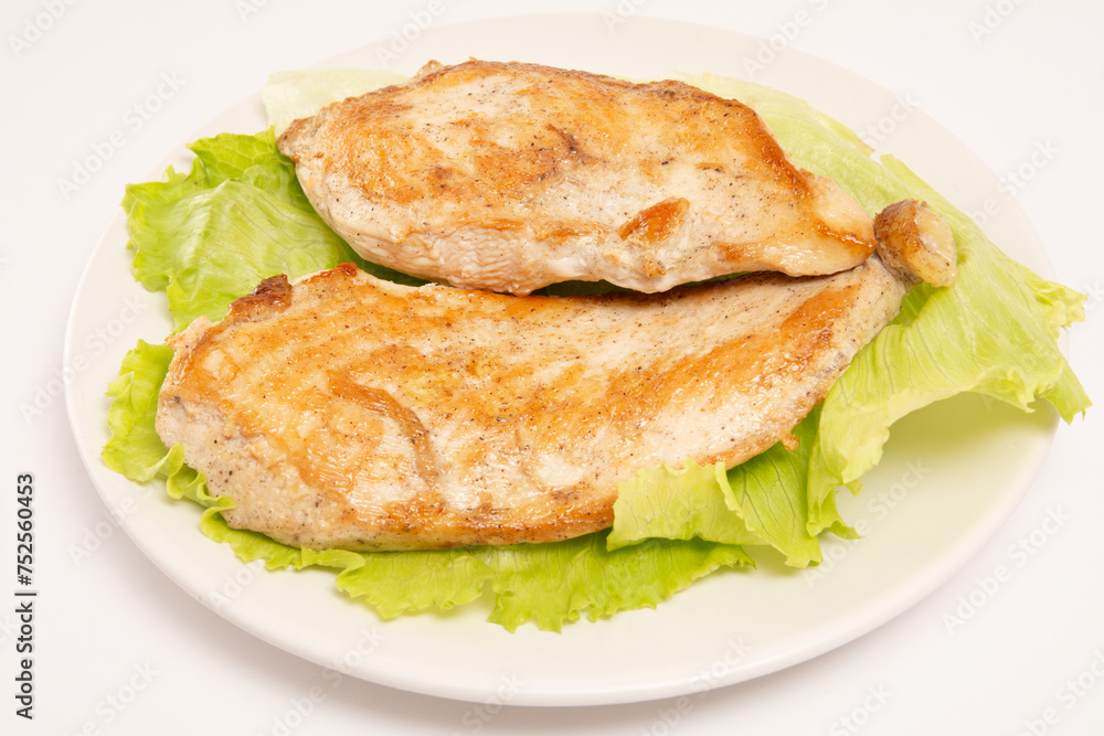 Grilled chicken in a plate with salad isolated clean white background top view photo