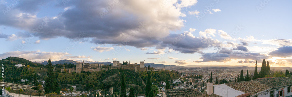 Panorama of fortress of Alhambra on a hill top seen from the quarter Albaicin with mountains of Sierra Nevada in background, Granada, Andalusia, Spain