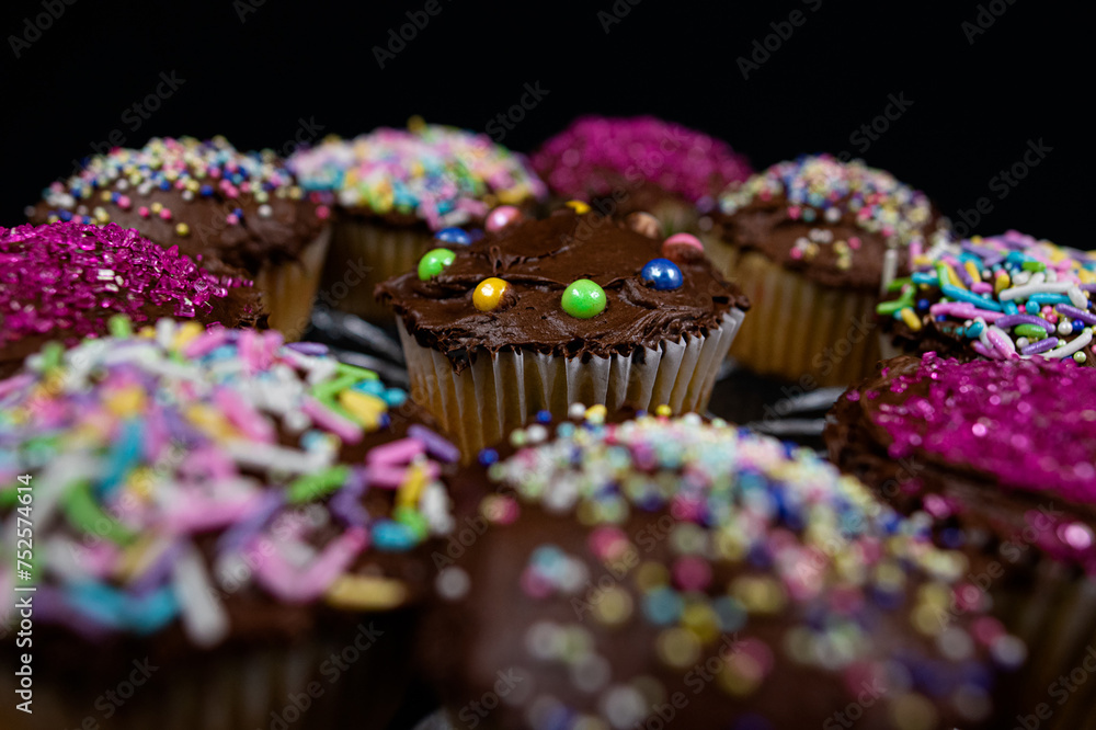 Vanilla Cupcakes With Chocolate Icing and Colorful Sprinkles Vanilla Cupcakes With Chocolate Icing and Colorful Sprinkles