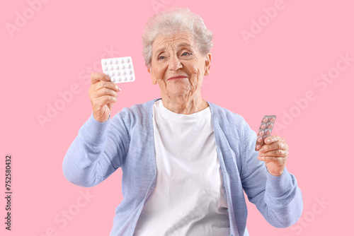 Senior woman with pills on ...