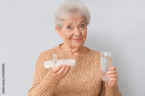 Senior woman with pill box ...