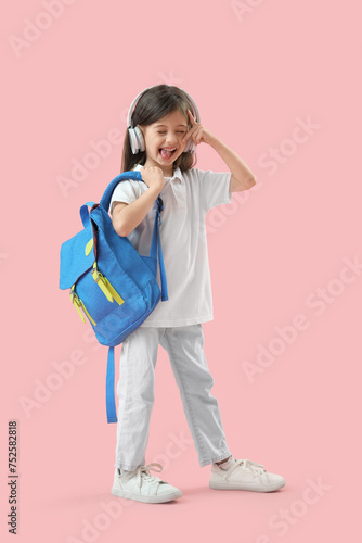 Cute little schoolgirl in h...