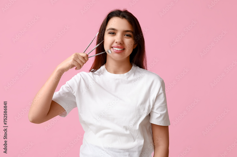 Female dentist with tools on pink background. World Dentist Day Female dentist with tools on pink background. World Dentist Day