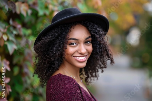 A vibrant outdoor portrait of a smiling young woman in a fashionable hat, radiating joy and confidence