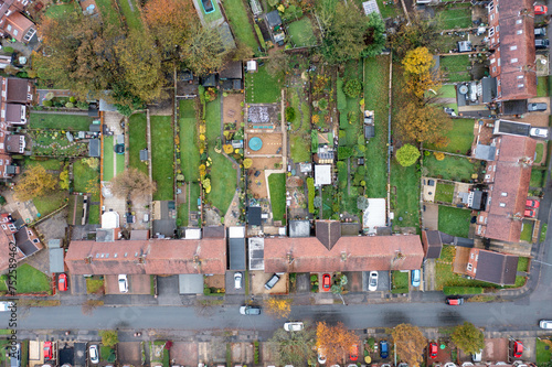 Obraz na płótnie Aerial drone photo of a typical British terrace house in the UK showing the roof of the house and the large garden in the winter time w salonie