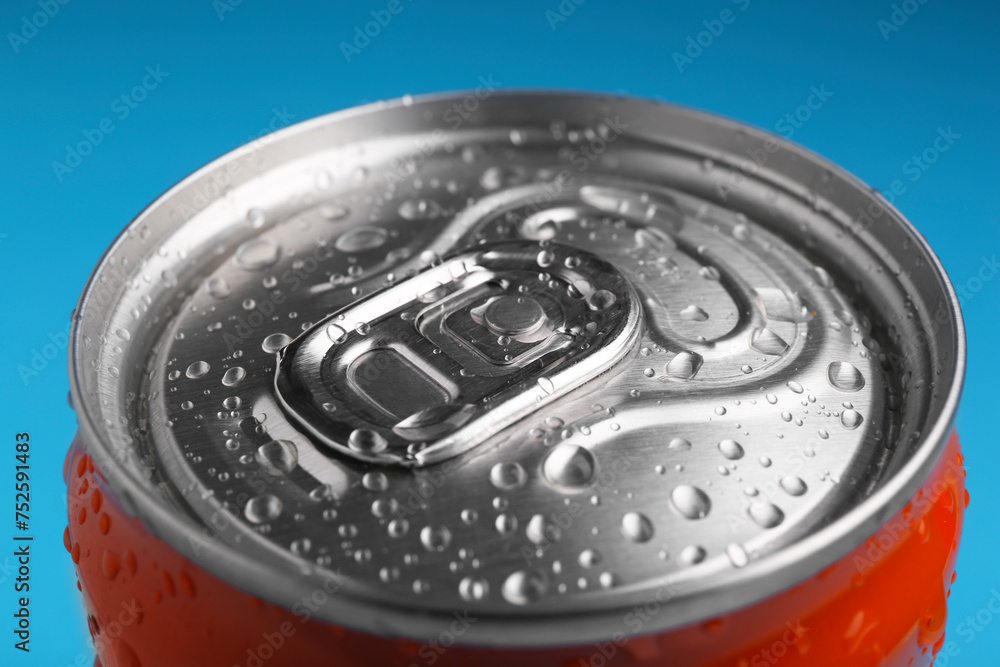 Energy drink in wet can on light blue background, closeup Energy drink in wet can on light blue background, closeup