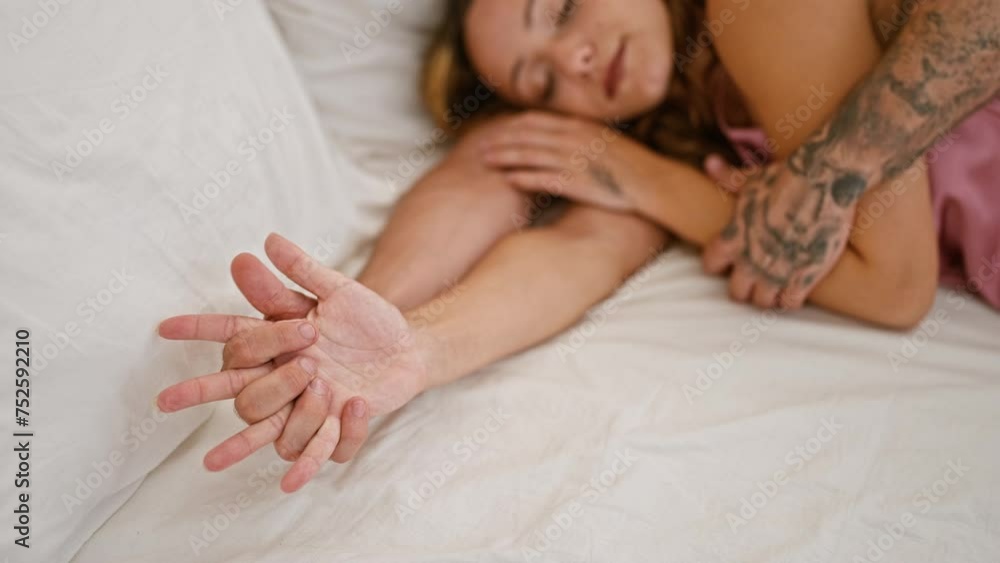 A man and woman in a loving embrace, sleeping peacefully together in a cozy bedroom setting, exemplifying a romantic couple's relationship.