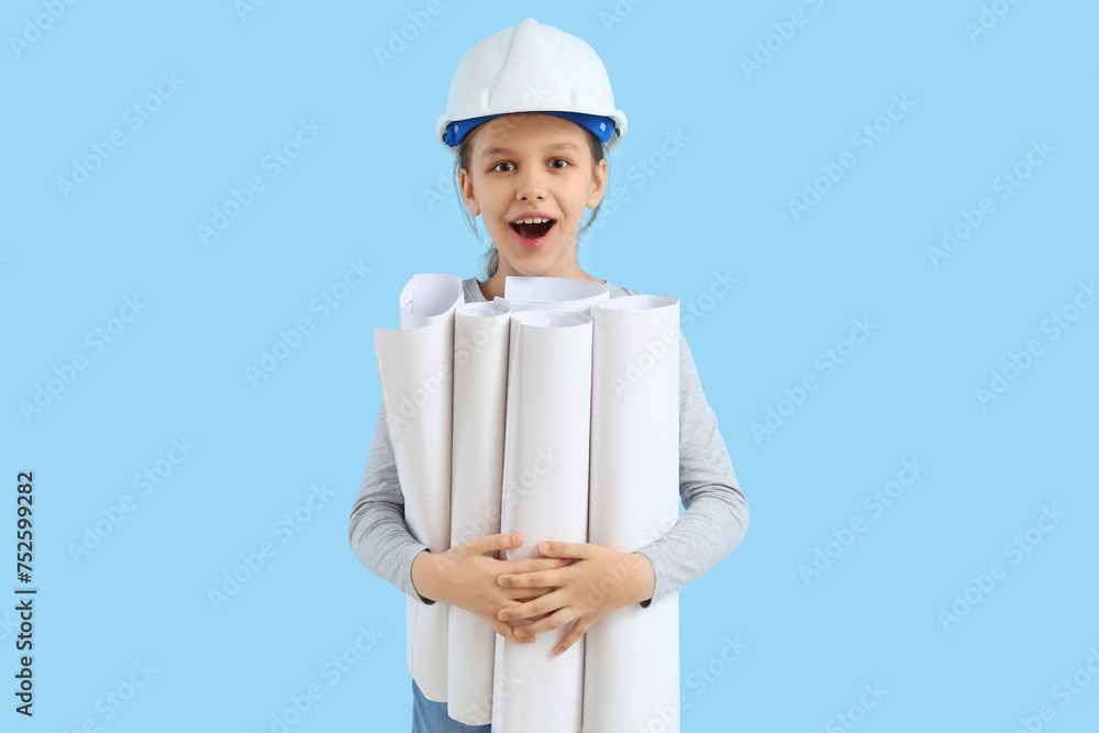 Surprised little architect with house plans on blue background Surprised little architect with house plans on blue background