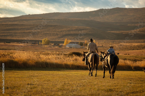 Father and Daughter Cowboy cowgirl riding horses