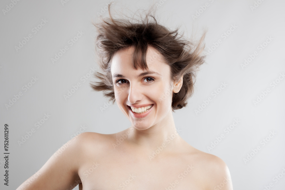 studio portrait of a beautiful brunette girl with short hair in the air studio portrait of a beautiful brunette girl with short hair in the air