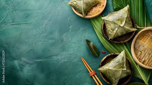 Zongzi, steamed rice dumplings on green table background, food in dragon boat festival duanwu concept, close up, copy space, top view, flat lay photo