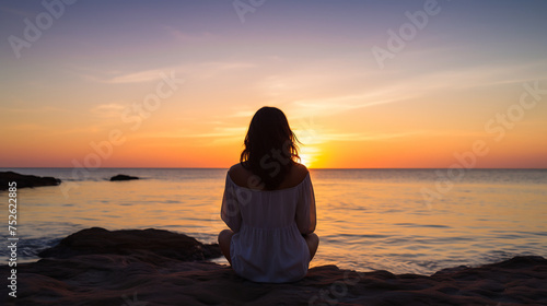 Contemplative Woman Watching the Sunset Over the Ocean. Serenity and Reflection Concept