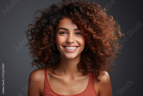 Portrait. Joyful brunette curly hair woman laughing on dark background. Generative AI  © Brastock Images / AI