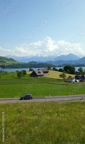 summer landscape with road, lake and mountains, background