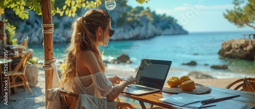 Fototapeta Naklejka Na Ścianę i Meble -  A woman enjoys the ultimate freedom of a digital nomad's life, working on a laptop at a beach cafe with a serene sea view.