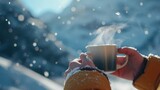 Close-up view of a hand holding a steaming hot coffee in cold winter.