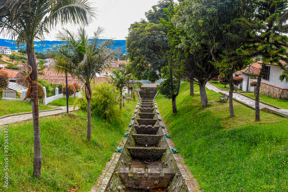 Scenic view of Guatavita, lush greenery, traditional architecture, and serene atmosphere